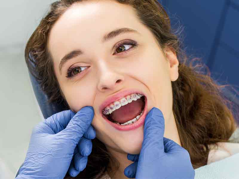 Girl with braces in orthodontist office